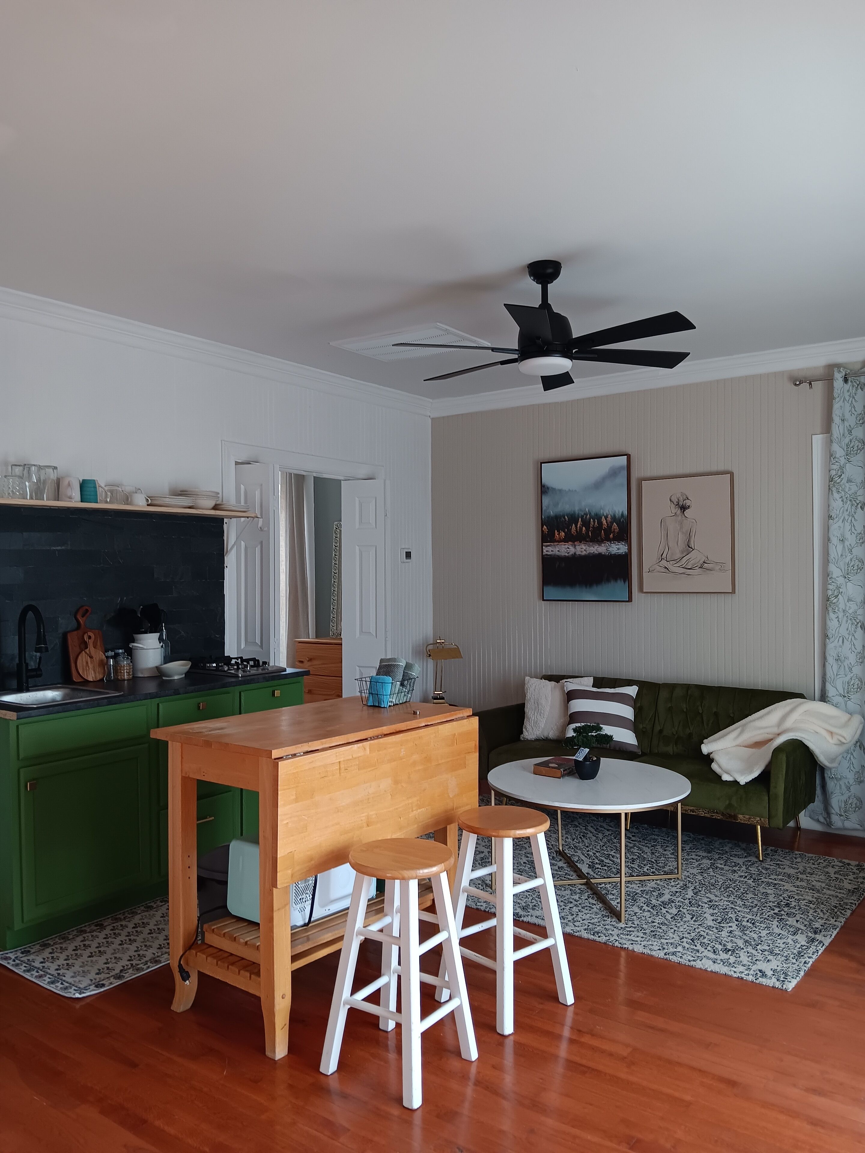 A compact living space with a kitchen, dining area, and seating area.
