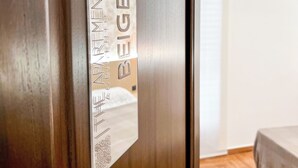 A wooden door with a sign indicating "The Men's Beige Room". - The Apartment Agrigento (Agrigento)