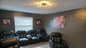 A room with a seating area featuring multiple black leather chairs and a single recliner. - 513Company - Theater +Location (Cincinnati)