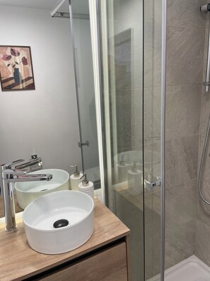 Shower, hair dryer, towels, soap