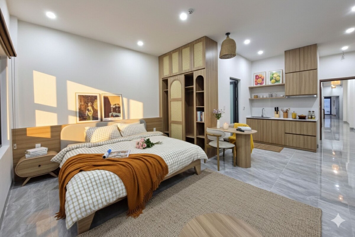 A modern bedroom with a large bed, bedside tables, a desk, and a wardrobe.