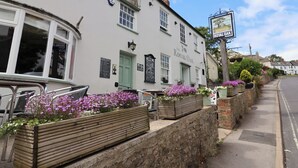 A traditional building with a sign reading "The Royal Oak" and a signboard for "Royal Oak" above the entrance. - Jurassic Discovery (Bridport)
