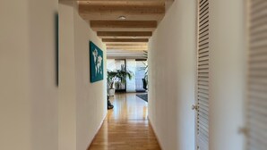 A hallway with wooden floors, white walls, and a ceiling with exposed beams. - Apartment “Black Forest Brandenkopfblick” with Terrace, Garden and Wi-Fi (Zell)