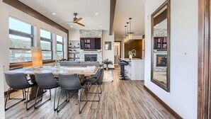 A spacious kitchen with a large island, dark wood flooring, and a view of the city through large windows. - AC in Downtown 2/2 with Mountain Views and easy access! (Winter Park)
