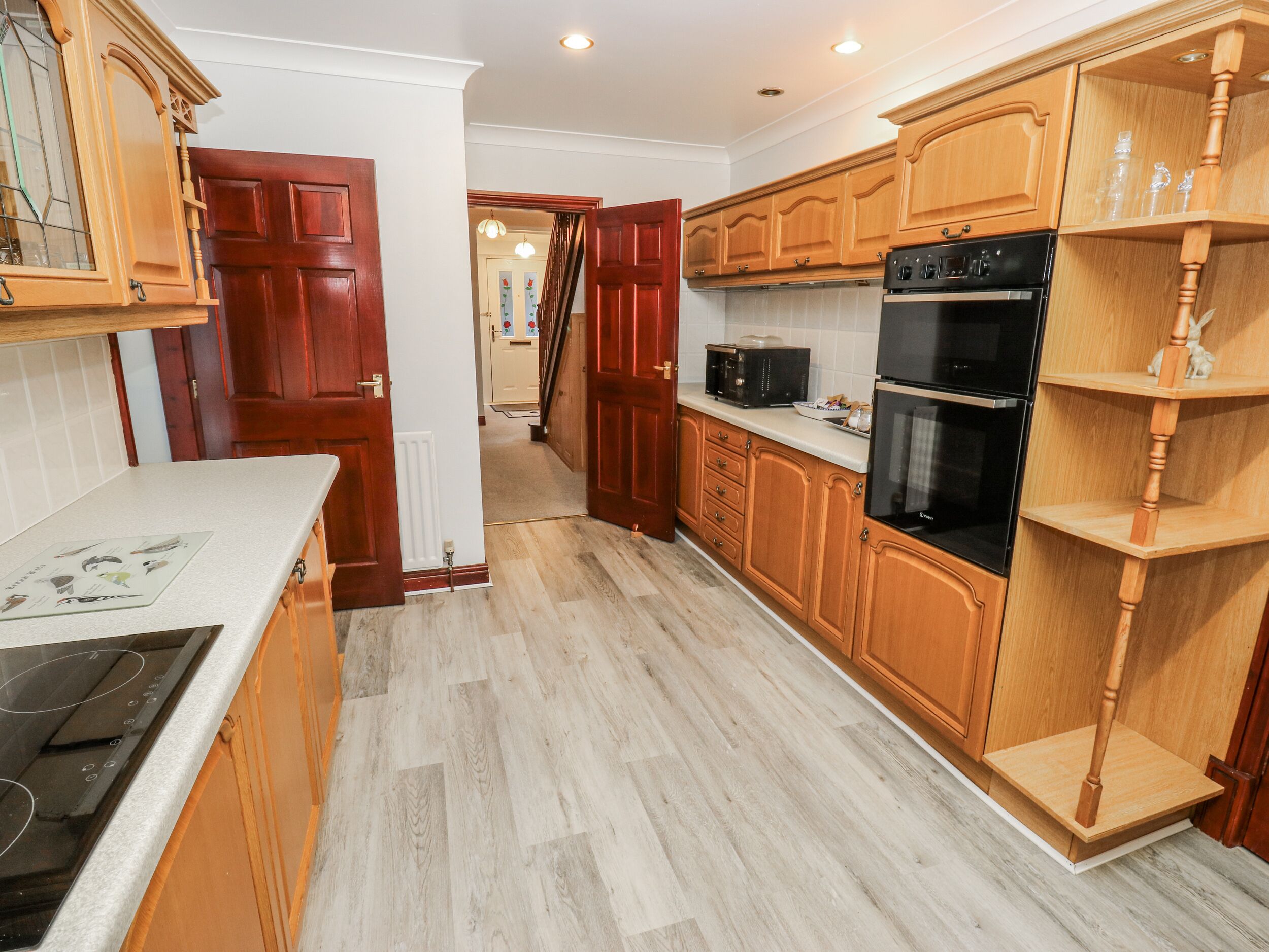 A kitchen with wooden cabinets, a microwave, a stove, and a refrigerator.