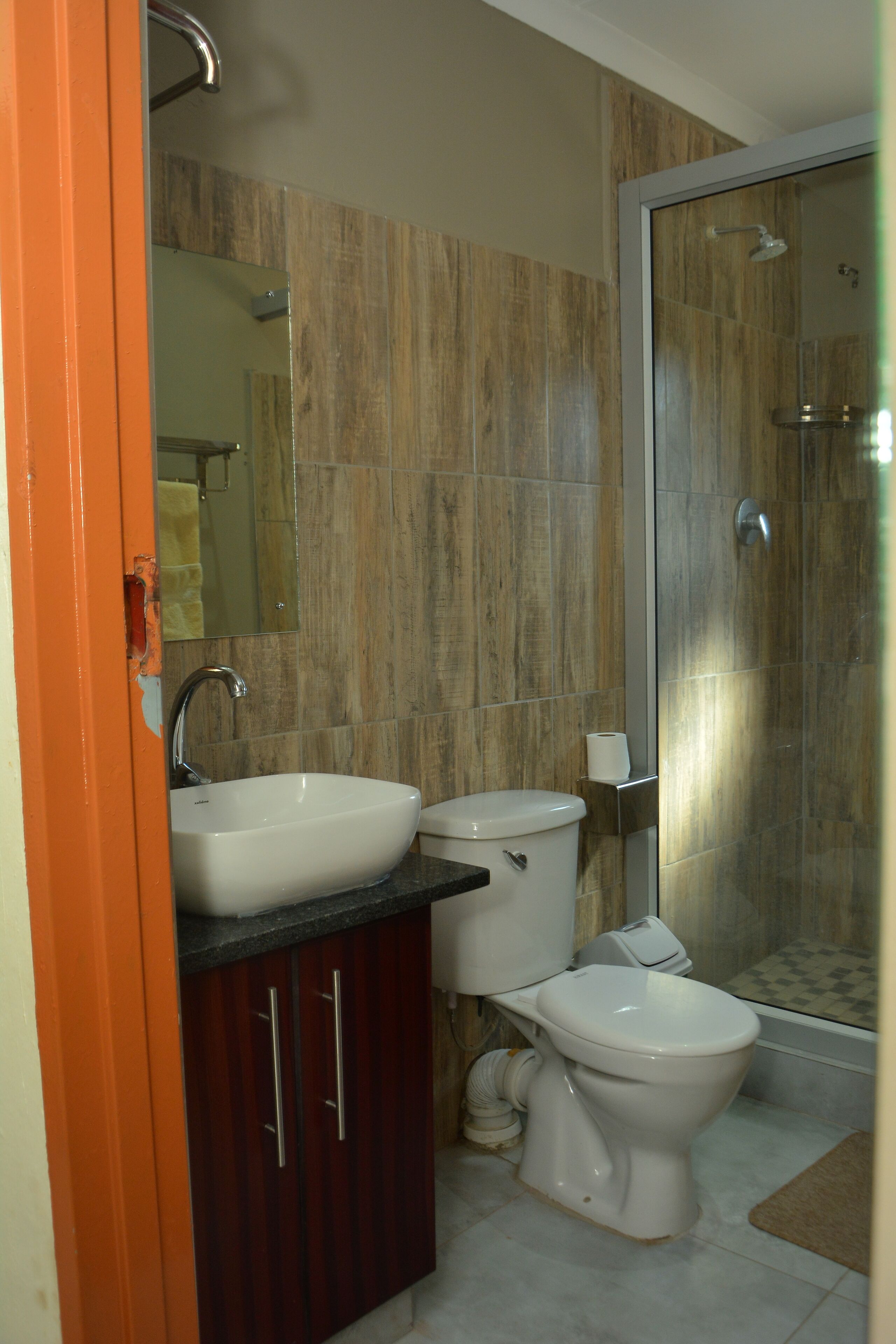 A bathroom with a sink, toilet, and shower.