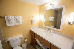 A bathroom with a white sink, mirror, and towel rack. - Oceanfront Studio w/ Balcony in Daytona Beach (Daytona Beach Shores)