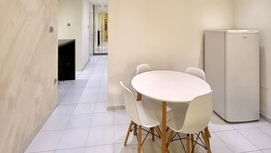 A modern kitchen with white cabinets, a built-in oven, and a refrigerator. - Adriatic Central 2BDR Apartment (Budva)