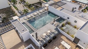 A rooftop pool with sun loungers, a small hot tub, and a wooden deck. - Almare by Andiani Travel (Cancun)
