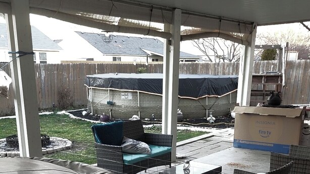 A covered patio area with a hot tub, outdoor furniture, and a fire pit. - The Wandering Viking! Skal!! (Boise)
