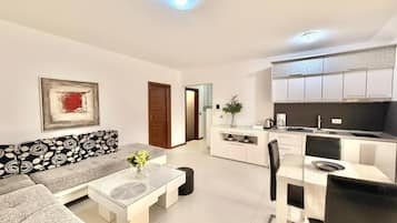 Apartamento de lujo, balcón | Zona de estar | Televisión LCD de 42 pulgadas con canales por cable