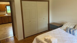 A bedroom with a bed, a nightstand, and a closet. - Lovely 2-bedroom apartment in charming Kingsford (Kingsford)