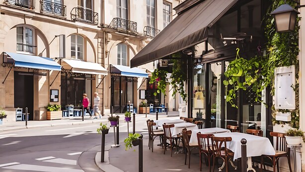 An outdoor cafe with tables and chairs, potted plants, and a pedestrian crossing. - JUST STEPS FROM THE ICONIC CHAMPS-ÉLYSÉES - SLEEPS 12 -  RUE LA BOÉTIE (Paris)