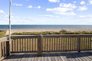 A wooden deck with a view of the beach and ocean. - Beachfront Home w/ Huge Deck, Sleeps 10 (Bolivar Peninsula)