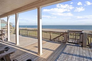 A wooden deck with a view of the beach and ocean. - Beachfront Home w/ Huge Deck, Sleeps 10 (Bolivar Peninsula)