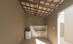A small, enclosed room with a kitchenette area, a sink, and a compact refrigerator. - House w/ Pool and Barbecue Grill Thg0006 (Porto Seguro)