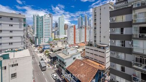 A cityscape with high-rise buildings, a street with vehicles, and a clear blue sky. - Apts Just 210m From the Beach in Balneario Camboriu - Edis (Balneário Camboriú)