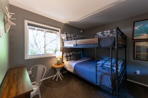 A bunk bed room with a desk, chair, lamp, and a window with a view of trees. - Bar7K Our Jackson Townhouse Hideaway -Walk to Town (Jackson)