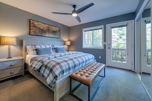 A bedroom with a bed, bedside tables, a ceiling fan, a window, and a door. - Bar7K Our Jackson Townhouse Hideaway -Walk to Town (Jackson)