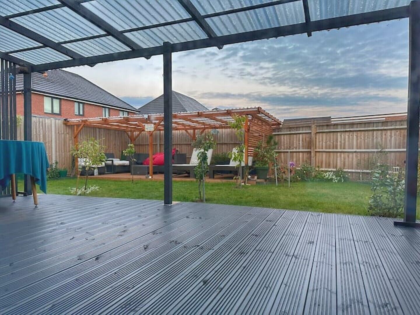 Rear garden with sunloungers and decking area