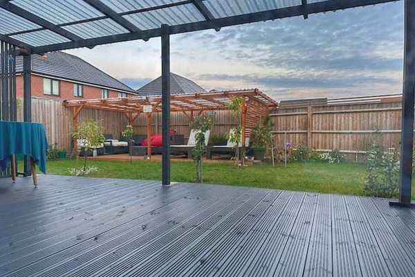 Rear garden with sunloungers and decking area