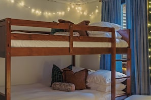Cozy bunk room with warm string lights—perfect for families or groups - The Painted Turtle: Lakefront, Hot Tub, Sauna, Theater, Game Room, Playset (Nisswa)