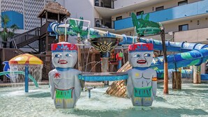A water park with two large, colorful statues, a slide, and a pool area. - Oceans 211 is a colorful newly renovated suite in the popular Oceans Reef resort (Myrtle Beach)