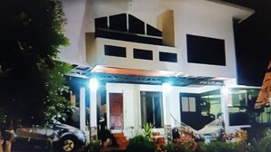 A two-story house with a covered porch and a car parked in front. - Escape to Your Private Costa Rican Jungle Retreat (Atenas)