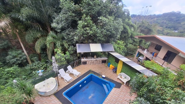A rooftop pool area with a hot tub, lounge chairs, and a covered seating area. - Escape to Your Private Costa Rican Jungle Retreat (Atenas)