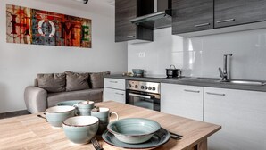 A modern kitchen with grey cabinets, a built-in oven, and a stainless steel sink. - 1 bedroom awesome apartment in Vir (Vir)