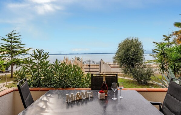 A table set for two with "Mr & Mrs" monogrammed letters, a bottle of champagne, and two wine glasses, overlooking a calm sea and a clear sky. - Luxurious apartment in Vir with house sea view (Vir)