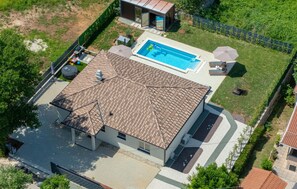 A residential property with a swimming pool, a covered patio, and a fenced yard. - Awesome home in Nedescina with sauna (Nedescina)