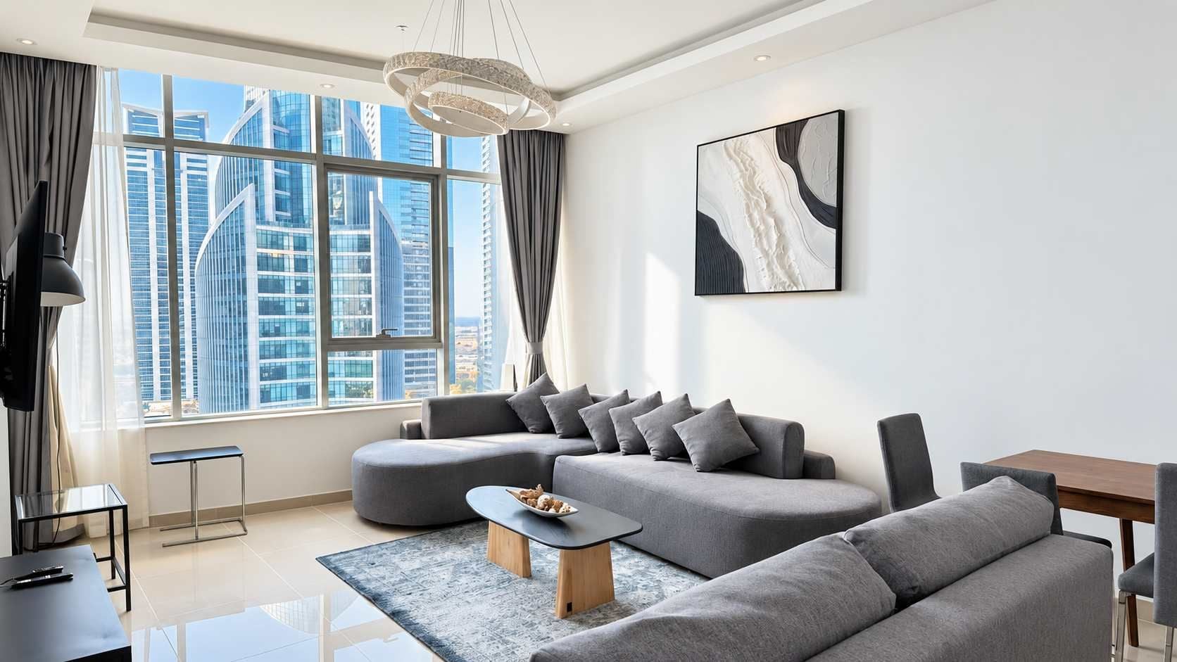A modern living room with a sectional sofa, a coffee table, and a dining area.