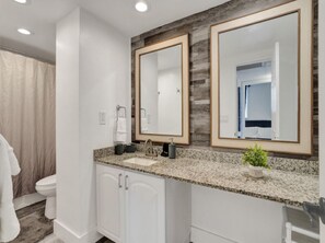 A bathroom with a double sink, two large mirrors, and a granite countertop. - Elegant Beachside Resort-Style Condo in Hollywood (Hollywood)