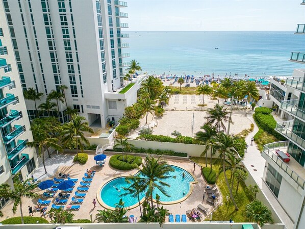 A hotel with a pool, beach area, and ocean view. - Elegant Beachside Resort-Style Condo in Hollywood (Hollywood)