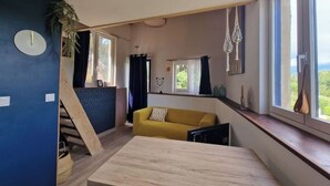A modern living room with a yellow sofa, a wooden coffee table, and a large window with curtains. - Cottage in the countryside - A haven of peace in Provence Verte [LA K-LINE] [LA K-LINE (Entrecasteaux)