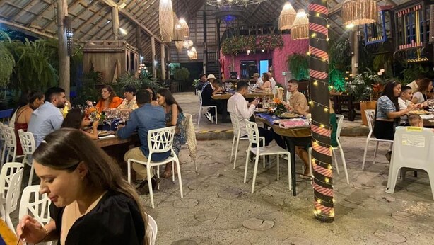 An indoor dining area with tables and chairs, a high ceiling with a wooden structure, and hanging light fixtures. - Hotel San Antonio del Cerro (Pereira)