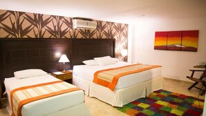 A hotel room with two beds, a colorful rug, a painting, and an air conditioning unit. - Hotel San Antonio del Cerro (Pereira)