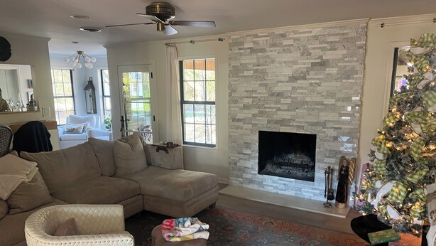 A living room with a sectional sofa, a fireplace, a Christmas tree, and a ceiling fan. - Walk to the Grove!From this 3BR 2 Bath!! (Oxford)