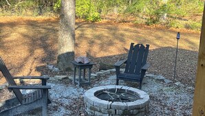A wooden deck with a stone fire pit, two Adirondack chairs, and a small table. - Walk to the Grove!From this 3BR 2 Bath!! (Oxford)