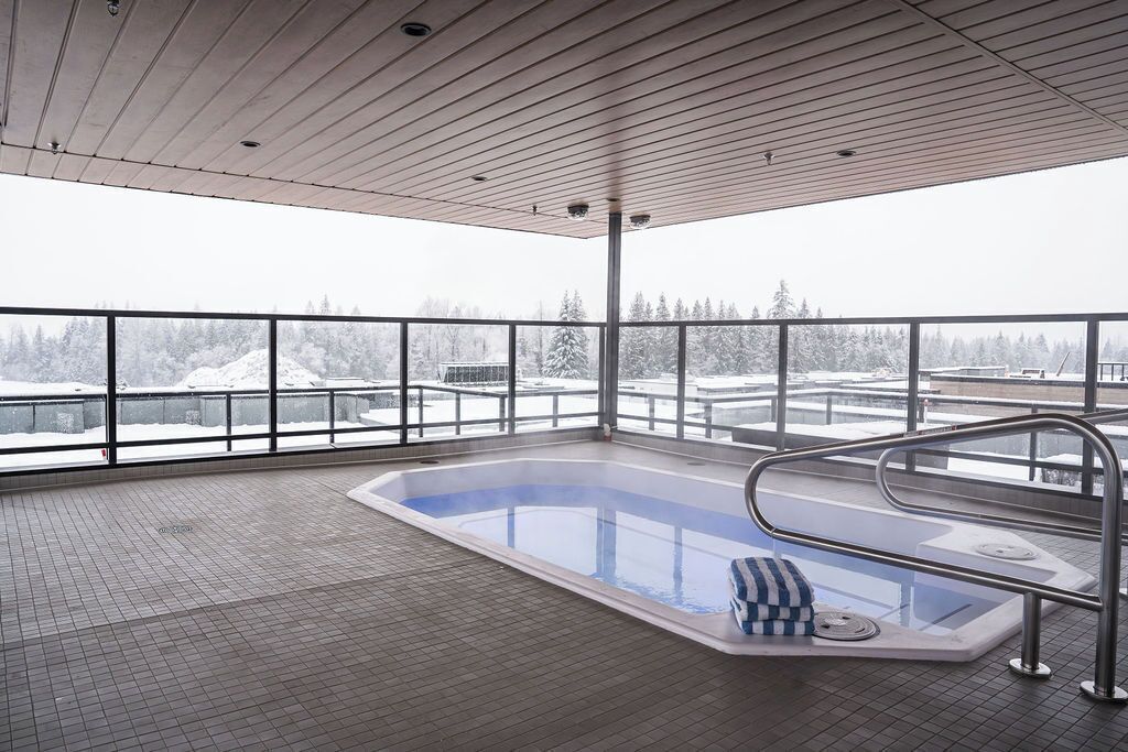 Una piscina interior moderna con vistas a un paisaje nevado.