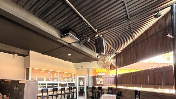 A spacious indoor area with a high ceiling, wooden flooring, and multiple seating arrangements. - Hotel Villa Jardín (Matamoros)