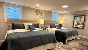 Een slaapkamer met twee bedden, een groot tapijt en een spiegel aan de muur.