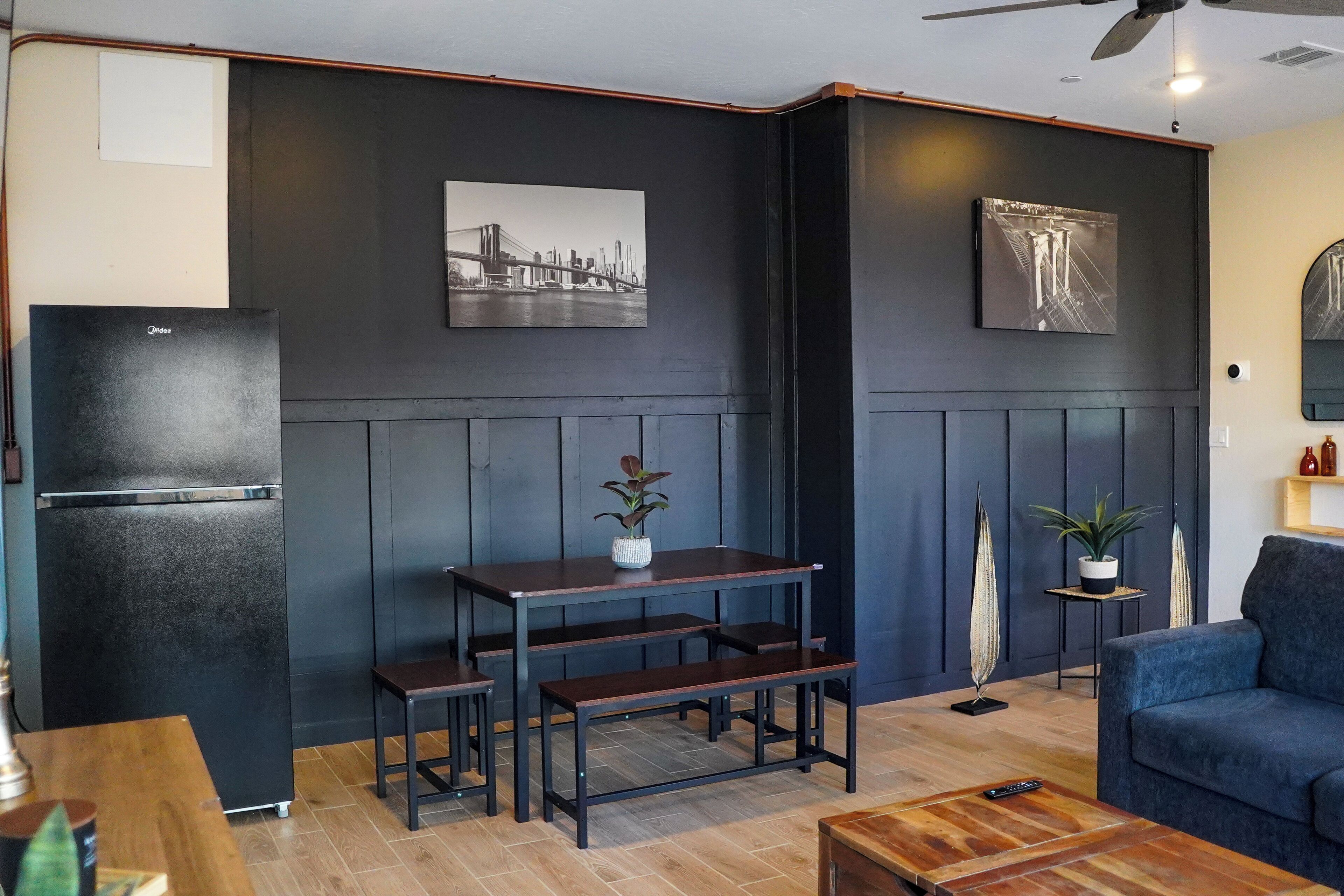 Open living-dining area with fridge, bright, comfy, and great for gatherings.
