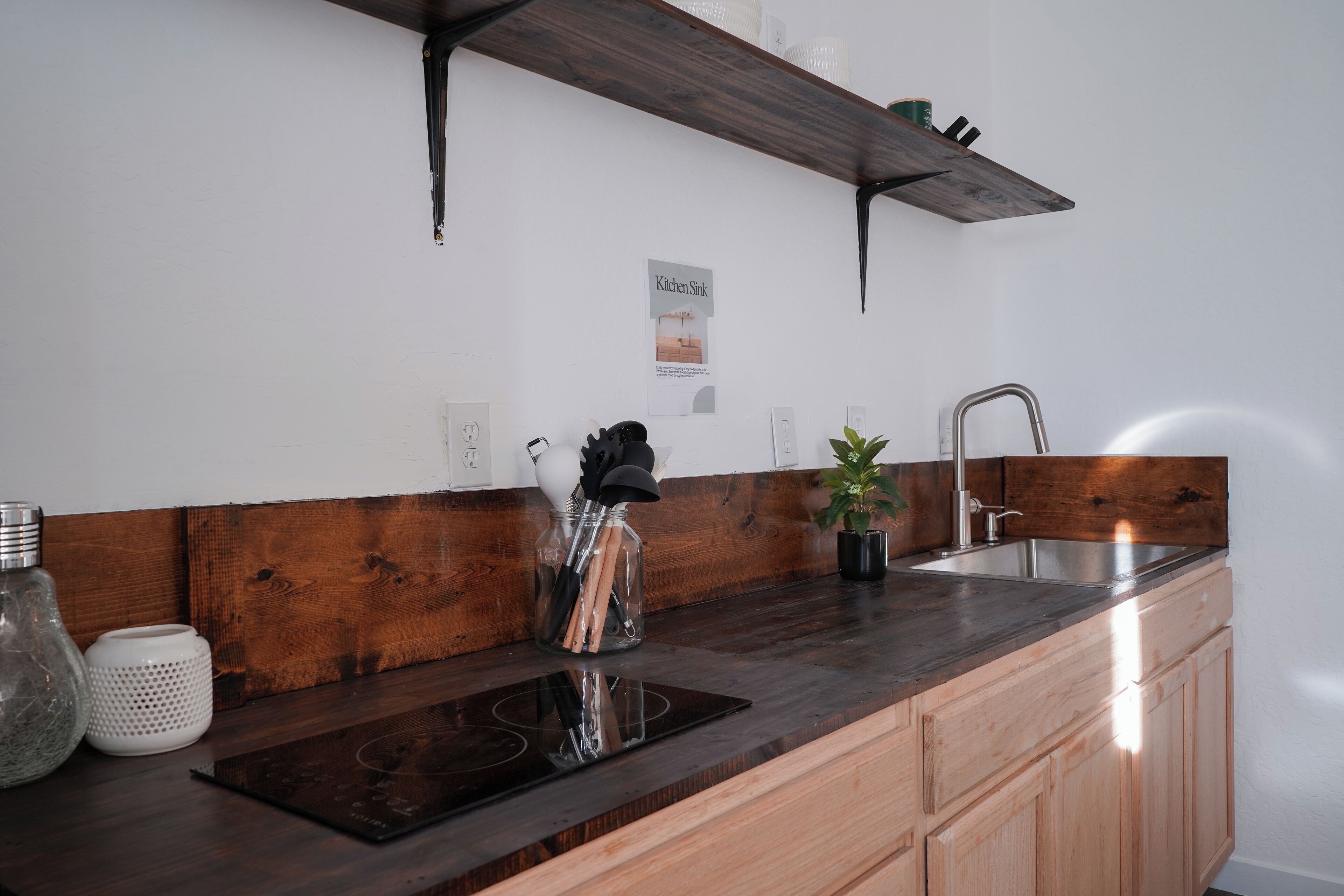 Two burner cooktop, deep sink and dedicated cook space.