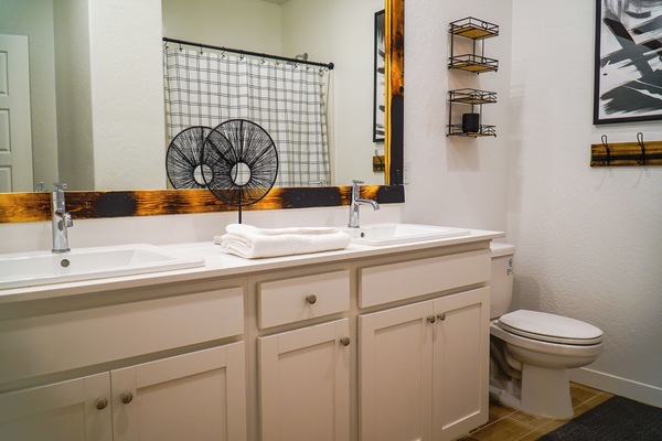 Elegant his and hers bathroom with a shower and a tub.