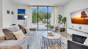 A modern living room with a sofa, coffee table, and TV.