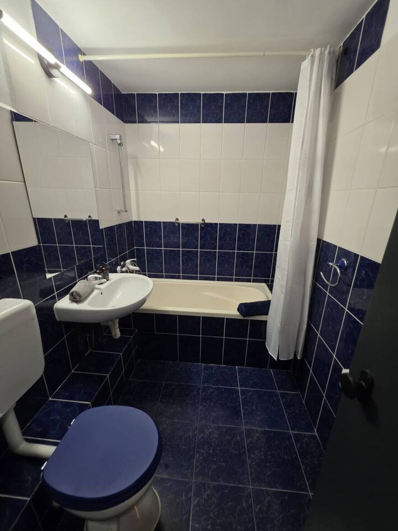 A bathroom with a bathtub, a sink, and a toilet.