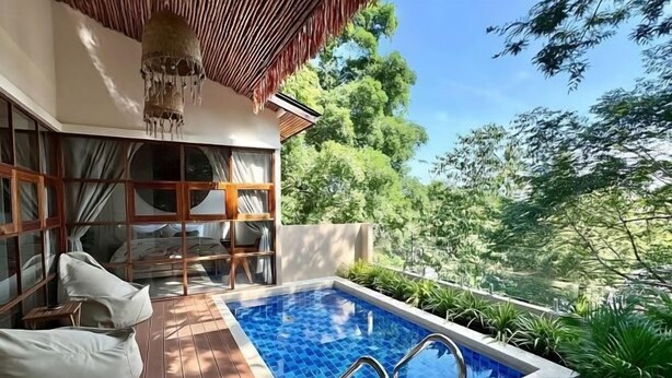 A pool area with a wooden deck, seating, and a view of the surrounding greenery. - Villa Uluwatu - Belle Vue Jungle, Villa 23 (Koh Samui)