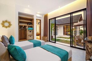 A hotel room with two beds, a wooden wardrobe, and a sliding glass door leading to an outdoor area. - Villa Crystal Lagoon by BaliSuperHost (Bali)